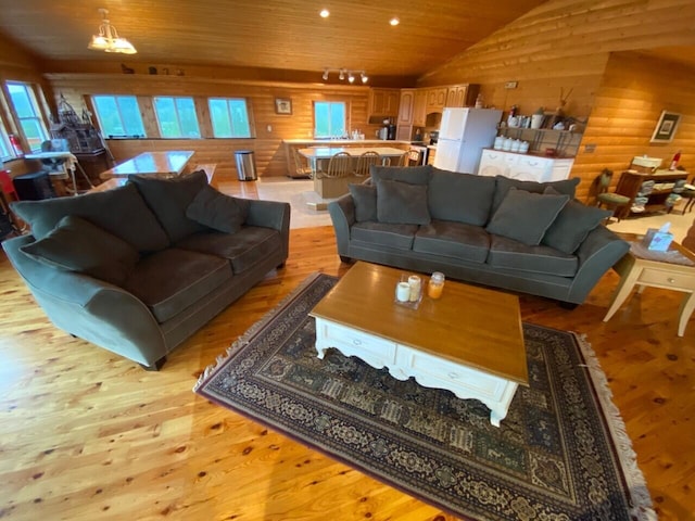 living room featuring light hardwood / wood-style flooring, a chandelier, wood ceiling, and vaulted ceiling