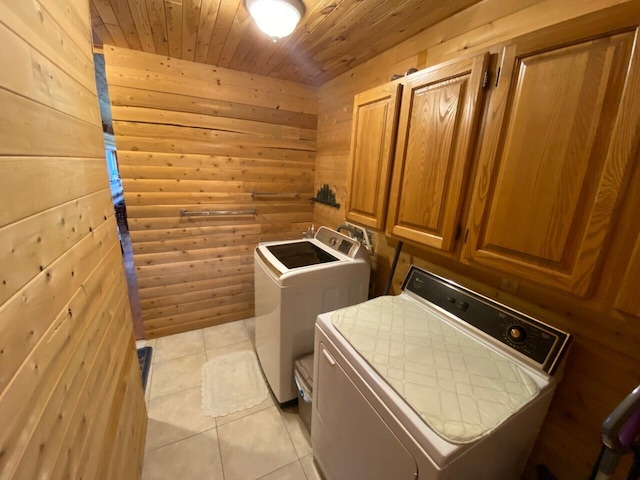 washroom with wood walls, wood ceiling, and washer and clothes dryer