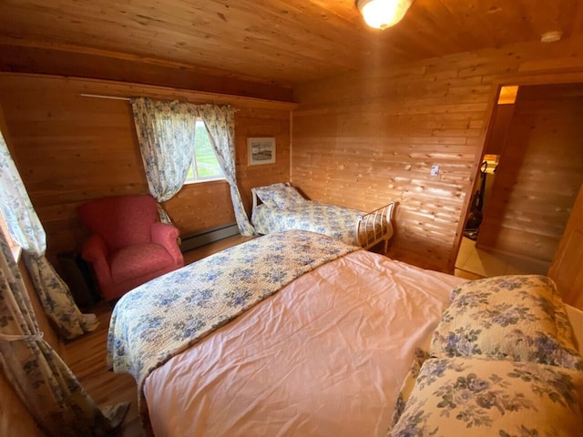 bedroom with wooden ceiling, baseboard heating, and wooden walls