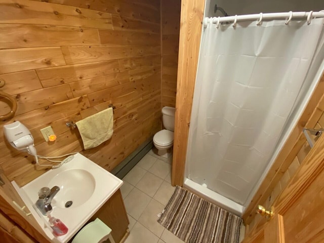 bathroom with toilet, tile floors, wood walls, and vanity