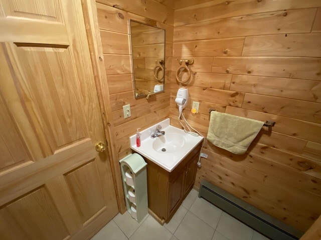 bathroom featuring wood walls, tile floors, oversized vanity, and baseboard heating