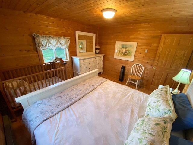 bedroom featuring wood ceiling and wood walls