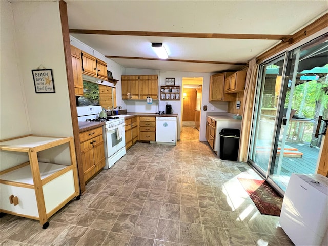 kitchen with beam ceiling, white appliances, sink, and light tile floors