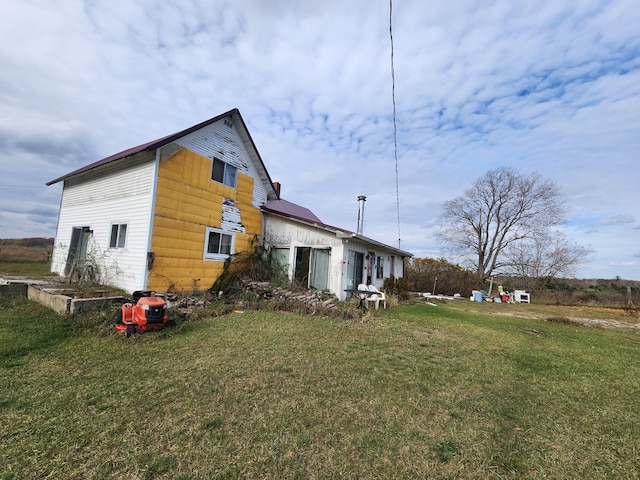 view of home's exterior featuring a lawn