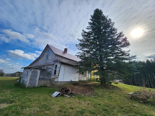 view of property exterior with a yard