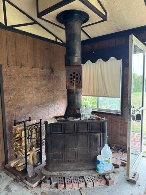 interior details featuring concrete flooring and a wood stove