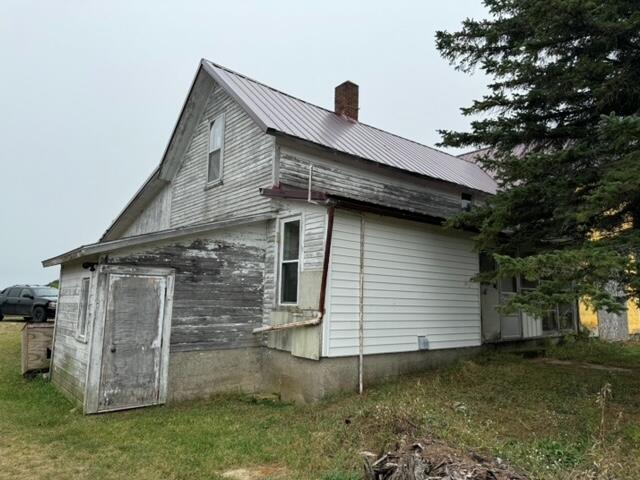 view of side of home featuring a lawn