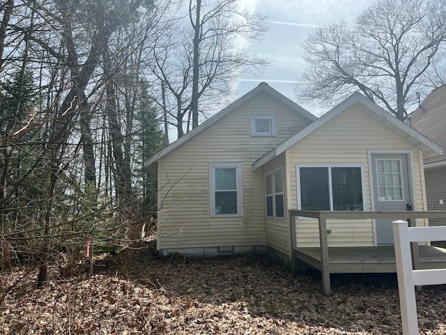 rear view of property with a wooden deck