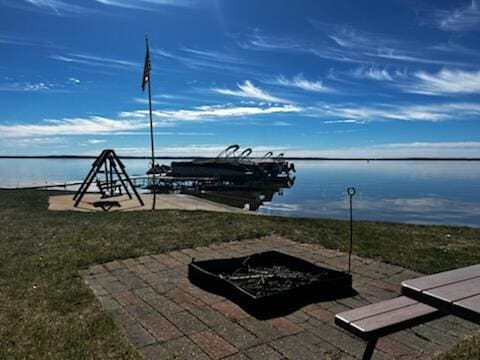 dock area with a fire pit and a water view