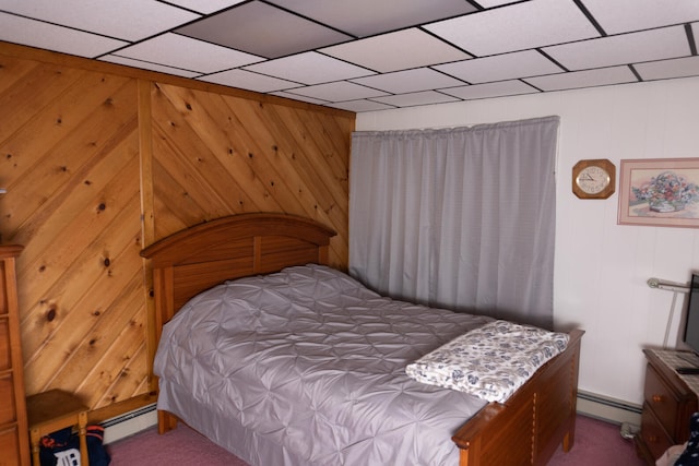 bedroom featuring baseboard heating, a paneled ceiling, and carpet