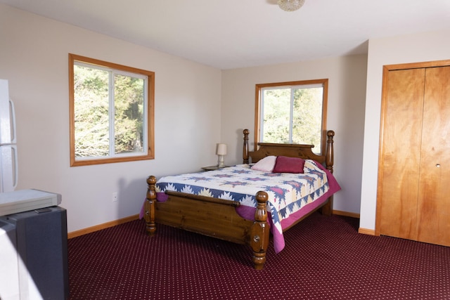 carpeted bedroom featuring white refrigerator