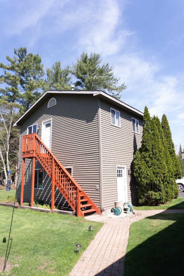 back of house with a wooden deck and a yard