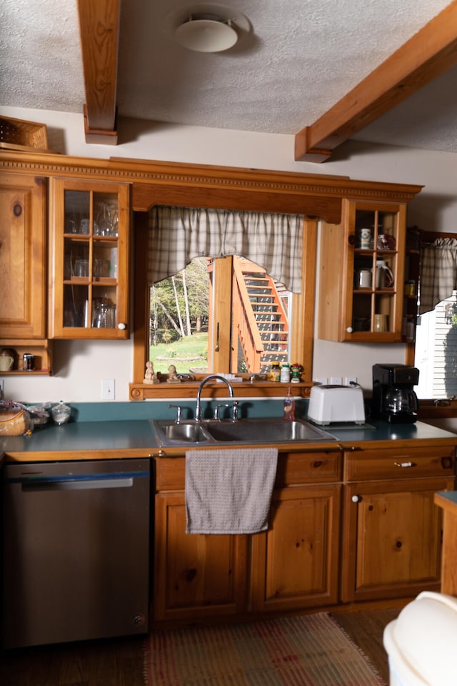 kitchen featuring a textured ceiling, sink, dishwasher, and beam ceiling