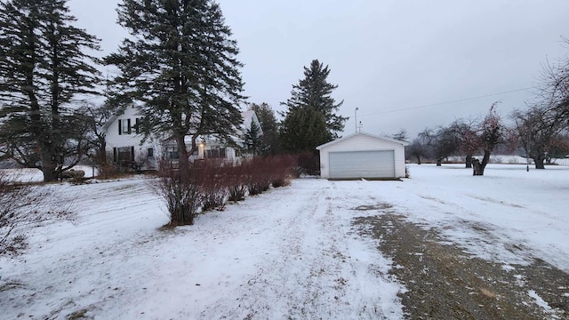 snow covered property featuring a garage