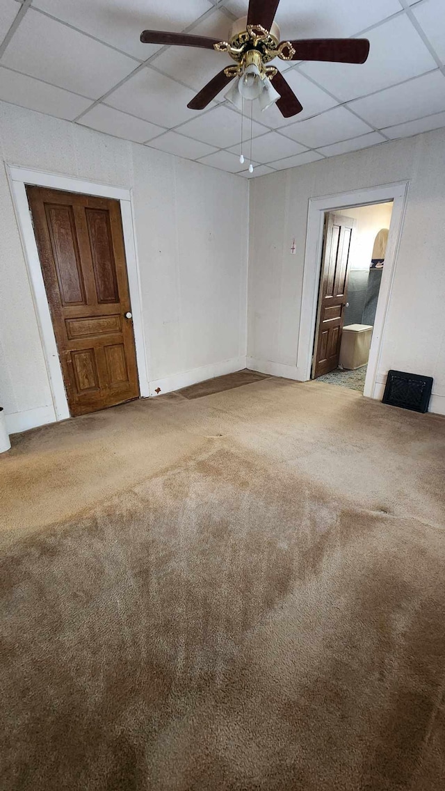 unfurnished bedroom featuring light colored carpet, ceiling fan, and a paneled ceiling