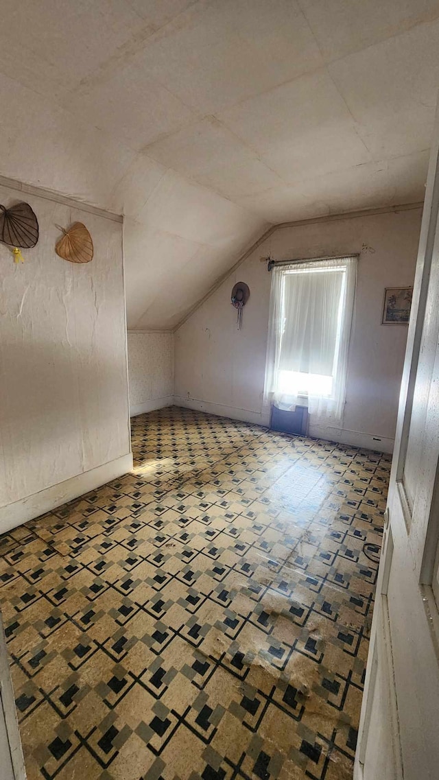 additional living space featuring vaulted ceiling