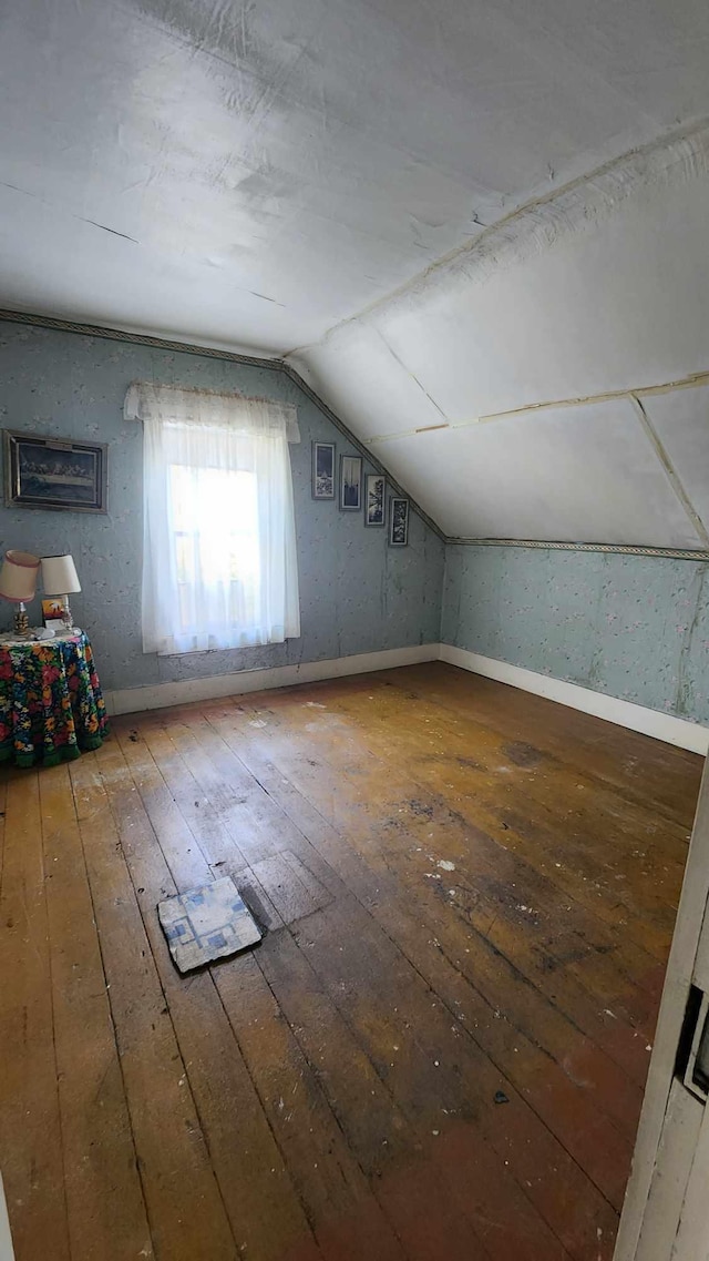 bonus room with hardwood / wood-style floors and lofted ceiling