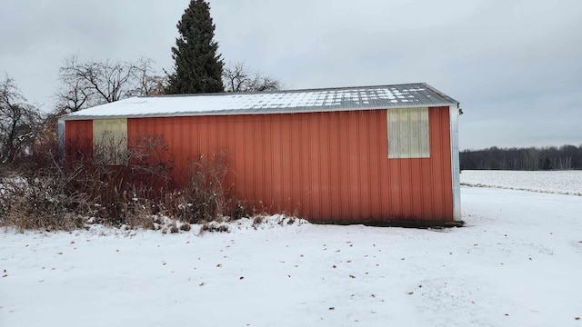 view of snowy exterior with an outdoor structure