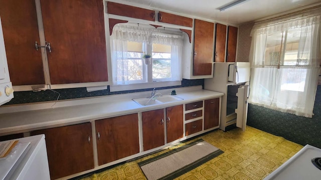 kitchen with sink and light tile flooring