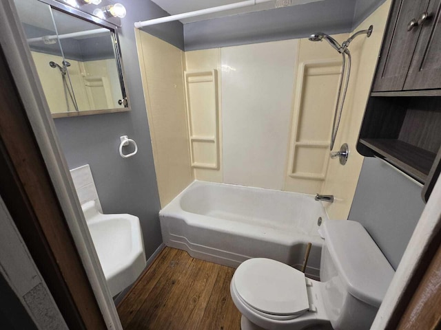 bathroom with toilet, hardwood / wood-style floors, and shower / tub combination