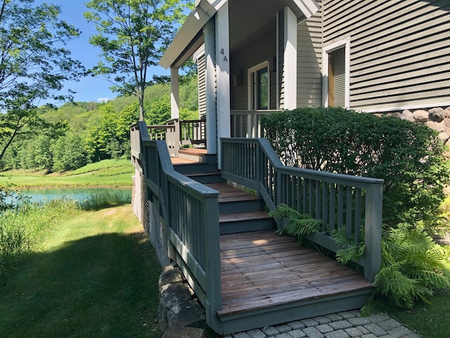 wooden terrace featuring a yard