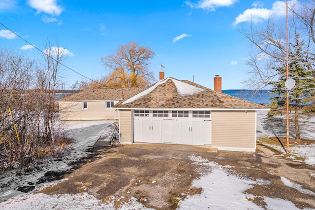 snow covered property featuring a garage