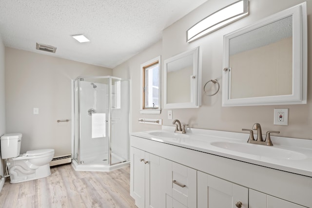 bathroom with hardwood / wood-style floors, a textured ceiling, a baseboard radiator, and a shower with shower door