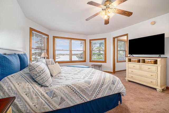 bedroom with ceiling fan and light carpet