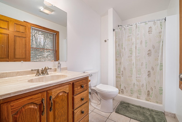 bathroom featuring tile floors, toilet, and vanity