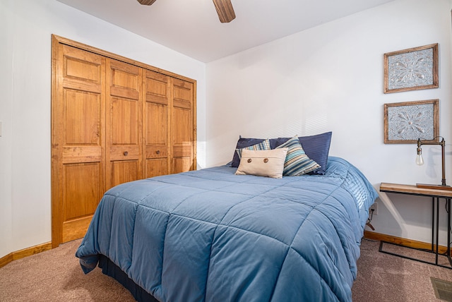 carpeted bedroom with ceiling fan and a closet