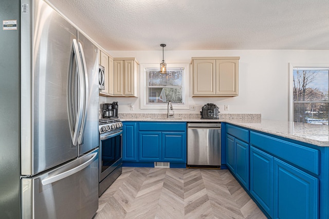 kitchen featuring light stone countertops, stainless steel appliances, light parquet flooring, and decorative light fixtures