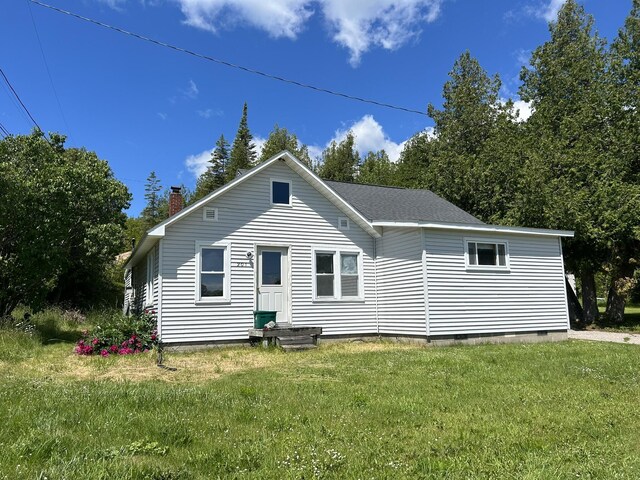 rear view of property with a yard