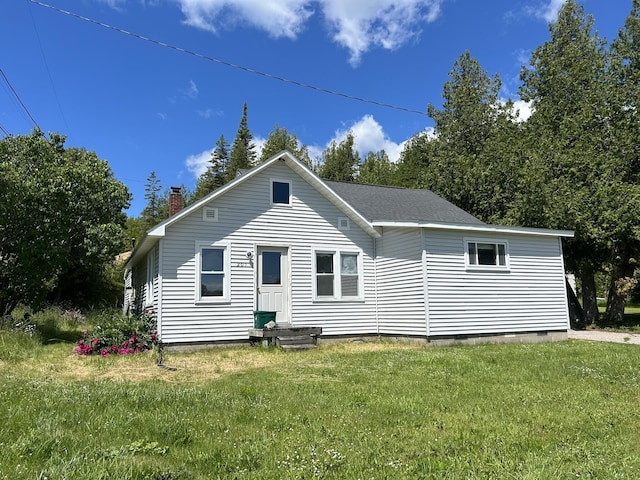 rear view of house with a yard