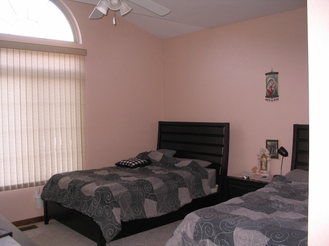 carpeted bedroom featuring ceiling fan and lofted ceiling