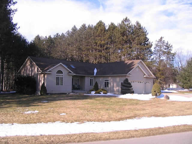 ranch-style house featuring a front yard and a garage