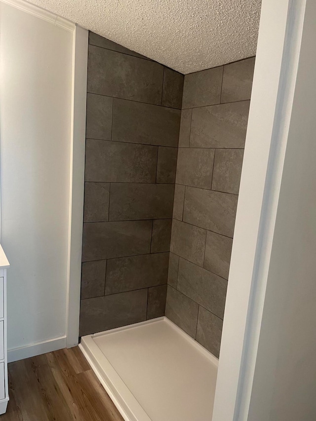 bathroom featuring a textured ceiling, vanity, and hardwood / wood-style floors