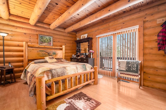 bedroom with beam ceiling, wood ceiling, rustic walls, and light hardwood / wood-style floors