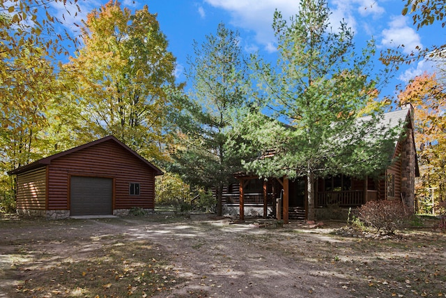 view of yard with a garage and an outbuilding