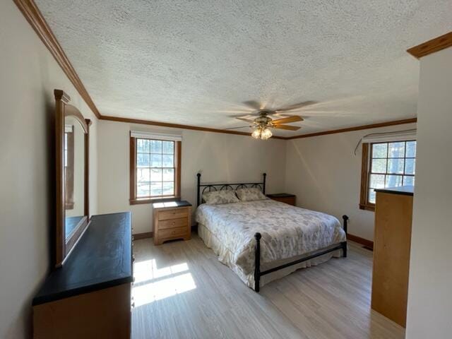 unfurnished bedroom with a textured ceiling, ceiling fan, light wood-type flooring, and ornamental molding