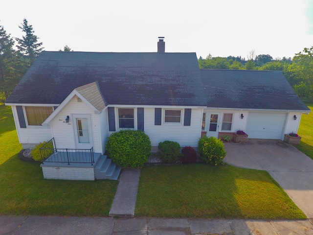 view of front of home with a front lawn and a garage