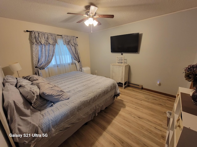 bedroom with light hardwood / wood-style floors, ceiling fan, a textured ceiling, and a baseboard heating unit