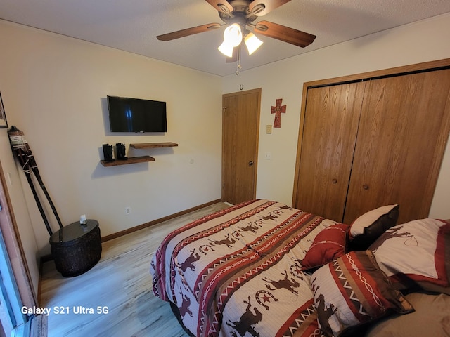 bedroom with a closet, ceiling fan, and light hardwood / wood-style flooring