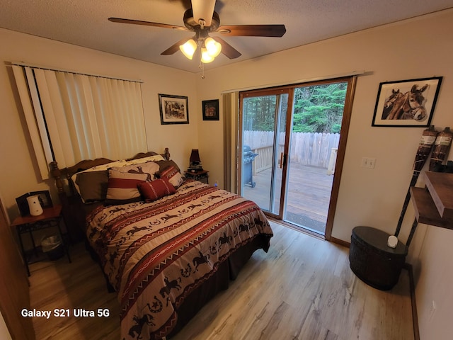 bedroom with ceiling fan, access to outside, light hardwood / wood-style floors, and multiple windows