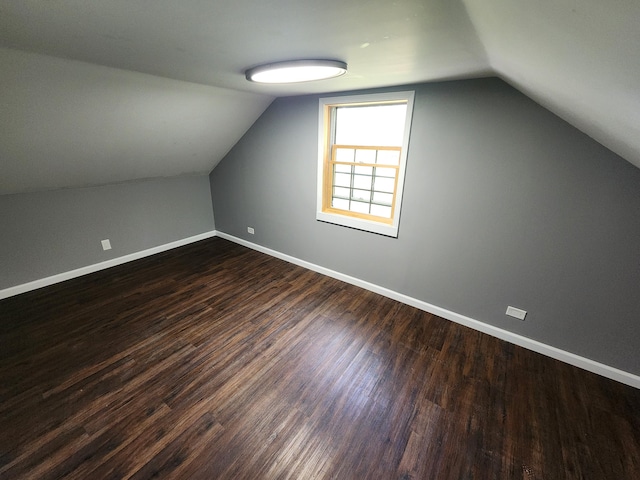 additional living space featuring hardwood / wood-style flooring and lofted ceiling