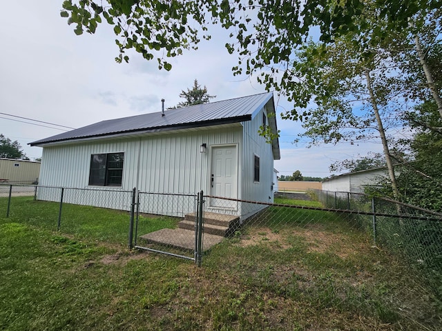 rear view of property with a yard