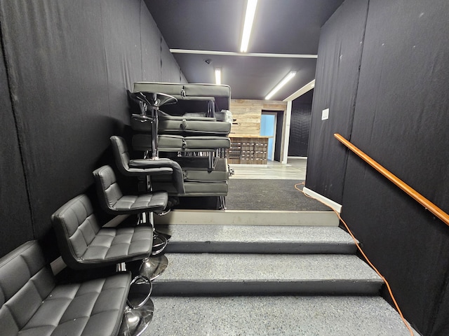 staircase featuring wooden walls