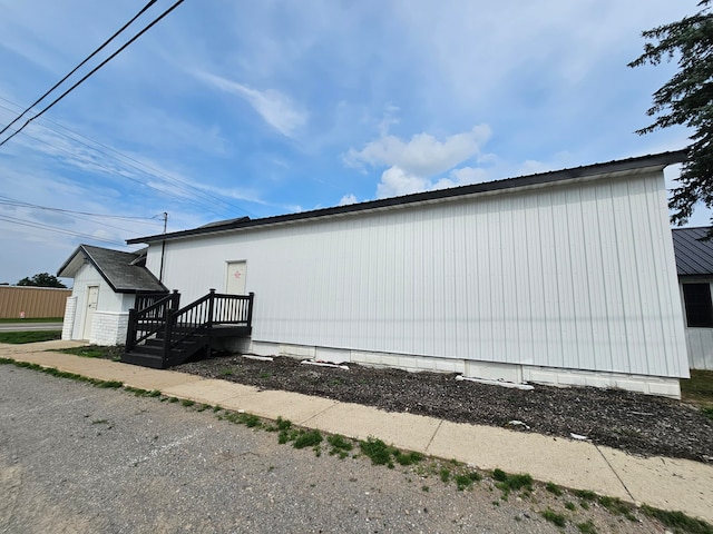 view of property exterior with a garage and an outdoor structure