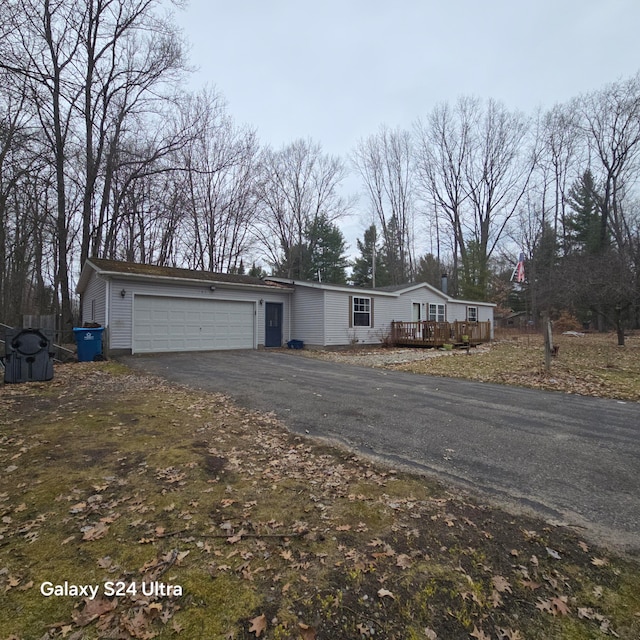 view of front facade with a wooden deck and a garage