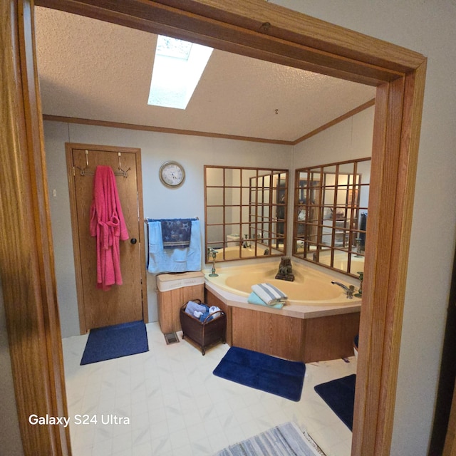 bathroom featuring a tub, a textured ceiling, tile flooring, and vaulted ceiling with skylight