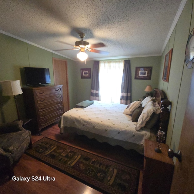 bedroom with dark hardwood / wood-style flooring, ceiling fan, crown molding, and a textured ceiling